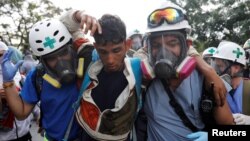 Volunteers help an injured demonstrator (center) during a rally against Venezuela's President Nicolas Maduro in Caracas, Venezuela, April 24, 2017. 