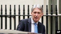 FILE - Britain's Chancellor of the Exchequer Philip Hammond leaves 11 Downing Street, in London, Dec. 10, 2018. 
