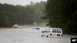 An American Red Cross van is stranded in floodwaters on U.S. Hwy. 17 North near Georgetown, S.C., Sunday, Oct. 4, 2015.