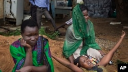 FILE - relatives of Samual Moro, 30, grieve after he died of cholera, outside the cholera isolation ward at the Juba Teaching Hospital in the capital Juba, South Sudan.