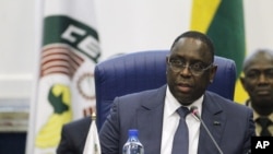 Senegal's President Macky Sall, seen in this Dec. 2015 file photo in Abuja, Nigeria, has come under pressure ahead of a constitutional referendum - set for March 20 - to limit presidential terms.