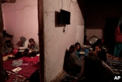 In this March 30, 2019 photo, women eat in Umm Yasser's home in Wadi Sahw, Abu Zenima, in South Sinai, Egypt. Four Bedouin women are for the first time leading tours in Egypt’s Sinai Peninsula. (AP Photo/Nariman El-Mofty)