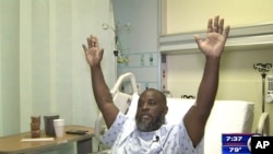 In this July 20, 2016, frame from video, Charles Kinsey explains in an interview from his hospital bed in Miami what happened when he was shot by police Monday. 