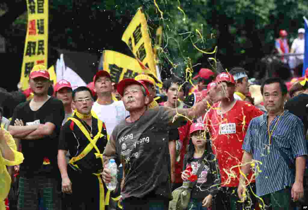 Poultry farmers hurl rotten eggs at police during a protest in front of the Ministry of Agriculture in Taipei, Taiwan. Over 1,000 poultry farmers took to the streets to protest the closing of live poultry markets last month, part of measures taken to prevent the outbreak of the H7N9 strain of bird flu.