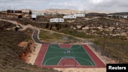 FILE - A basketball court is seen in the settler outpost of Amona near the Jewish settlement of Ofra, north of Ramallah, March 1, 2011. 
