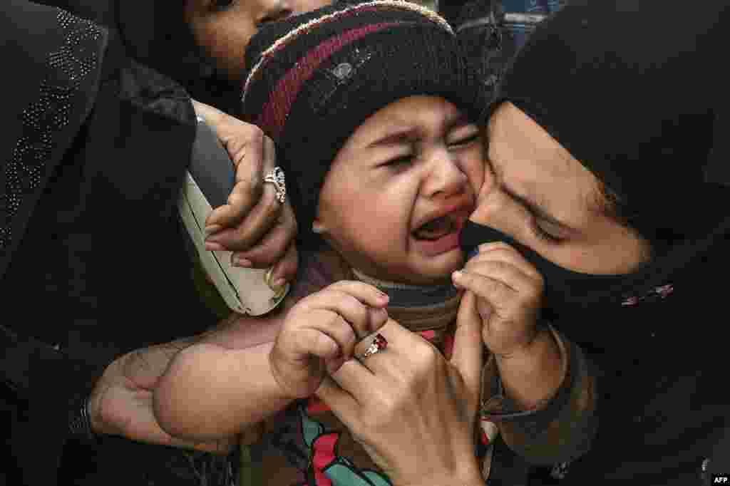 A child reacts as a health worker&nbsp;administers&nbsp;an Inactivated polio vaccine (IPV) during a polio vaccination campaign in Lahore, Pakistan.