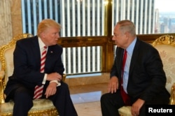 FILE - Israeli Prime Minister Benjamin Netanyahu, right, speaks to then U.S. presidential candidate Donald Trump during their meeting in New York, Sept. 25, 2016. When meeting Trump next week, Netanyahu is likely to make the pitch that sidelining Hezbollah is good for the security of the volatile Mideast.