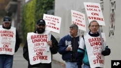A small group of picketers from Bakery and Confectioners Workers Union Local 9 walk past a closed Hostess plant, Seattle, Nov. 16, 2012.