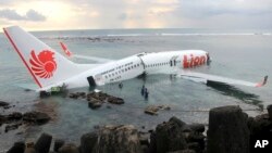 In this photo released by Indonesian police, the wreckage of a crashed Lion Air plane sits on the water near the airport in Bali, Indonesia, April 13, 2013. 