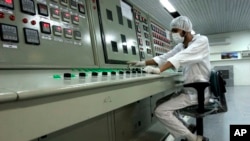 In this Feb. 3, 2007 file photo, an Iranian technician works at the Uranium Conversion Facility just outside the city of Isfahan, Iran, 255 miles (410 kilometers) south of the capital Tehran. 
