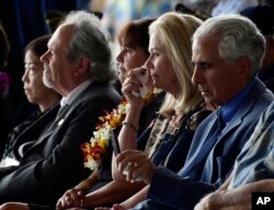 Robert Sanfilkippo, right, sits next to his wife, Diana Brown Sanfilippo who has spent a lifetime searching for her father, 1st Lt. Frank Salazar who died 66 years ago in North Korea, who wipes her eyes as she sits in the audience with Karen Pence, wife of Vice President Mike Pence, at a ceremony marking the arrival of the remains believed to be of American service members who fell in the Korean War at Joint Base Pearl Harbor-Hickam, Hawaii, Aug. 1, 2018.