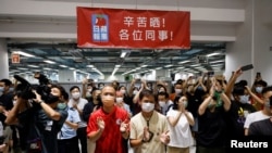 Staff members of Apple Daily and its publisher react on the day of the newspaper's final edition in Hong Kong, China June 23, 2021. (REUTERS/Tyrone Siu)