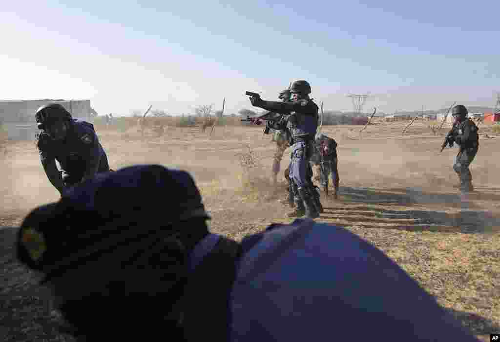 Police open fire on striking miners at the Lonmin Platinum Mine near Rustenburg, South Africa, August 16, 2012.