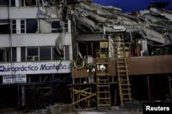Wreaths hang on a building that collapsed in an earthquake, after rescue teams retrieved the last body trapped in the rubble in Mexico City, Oct. 4, 2017.