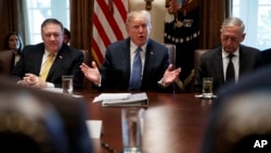 FILE - Secretary of State Mike Pompeo, left, and Secretary of Defense Jim Mattis, right, listen as President Donald Trump speaks during a Cabinet meeting at the White House, June 21, 2018. Trump is now in the process of selecting his Cabinet member for his second term.