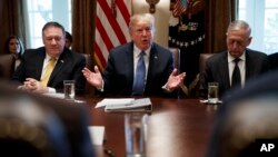 FILE - Secretary of State Mike Pompeo, left, and Secretary of Defense Jim Mattis, right, listen as President Donald Trump speaks during a cabinet meeting at the White House, June 21, 2018.