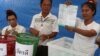 An electoral member shows a ballot during the vote counting, during the general election in Bangkok, Thailand, March 24, 2019. 