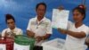 FILE - An electoral member shows a ballot during the vote counting, during the general election in Bangkok, Thailand, March 24, 2019. 