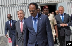 FILE - Somali president Mohamed Abdullahi Mohamed, centre, walks with UN Secretary-General Antonio Guterres, 2nd left, inside the UN compound in Mogadishu, Somalia, March 7, 2017.