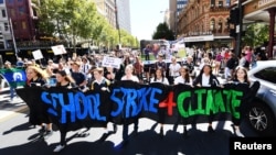 School students march up King William Street after attending the global #ClimateStrike rally at South Australia's Parliament House in Adelaide, Australia, March 15, 2019. 
