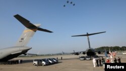 U.N. honor guards stand as they wait for caskets containing remains transferred by North Korea, at Osan Air Base in Pyeongtaek, South Korea, Aug. 1, 2018. 