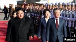 El presidente de Corea del Sur, Moon Jae-in, (derecha) y el líder de Corea del Norte, Kim Jong Un, caminan juntos en el aeropuerto cerca de Mt. Paektu, Corea del Norte, el jueves, 20 de septiembre de 2018.