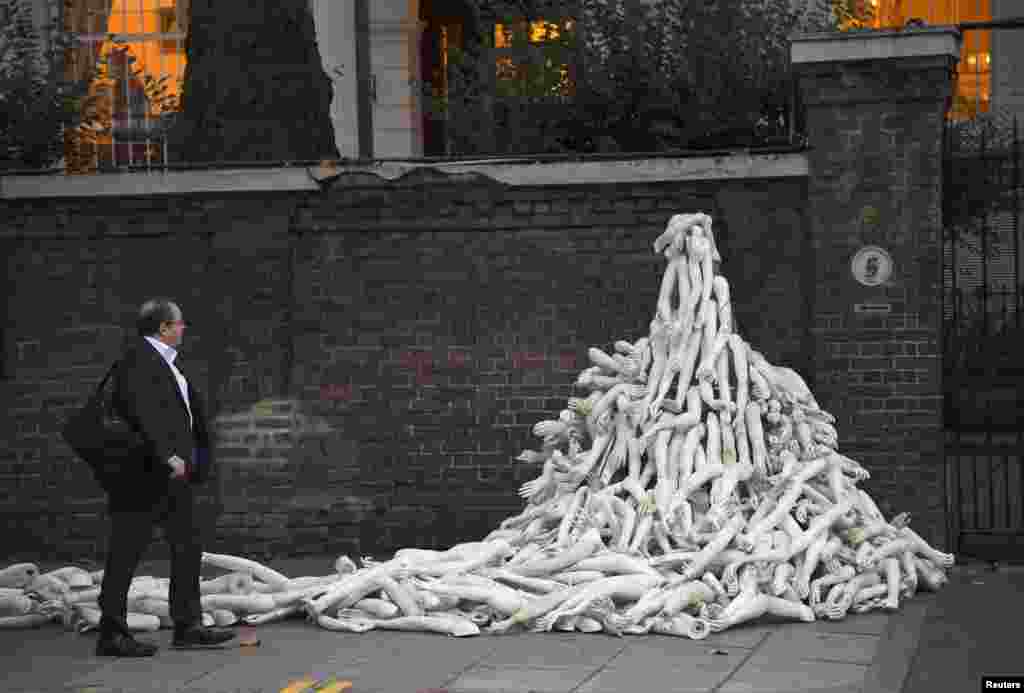 Piles of mannequin limbs are seen outside the Russian embassy in London - they are part of a protest against military action in Syria.