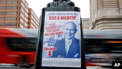 FILE - A sign criticizing U.S. Environmental Protection Agency Administrator Scott Pruitt is seen posted on the base of a utility pole in Washington, D.C., April 6, 2018.