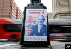 A sign criticizing U.S. Environmental Protection Agency Administrator Scott Pruitt is seen posted on the base of a utility pole in Washington, April 6, 2018.