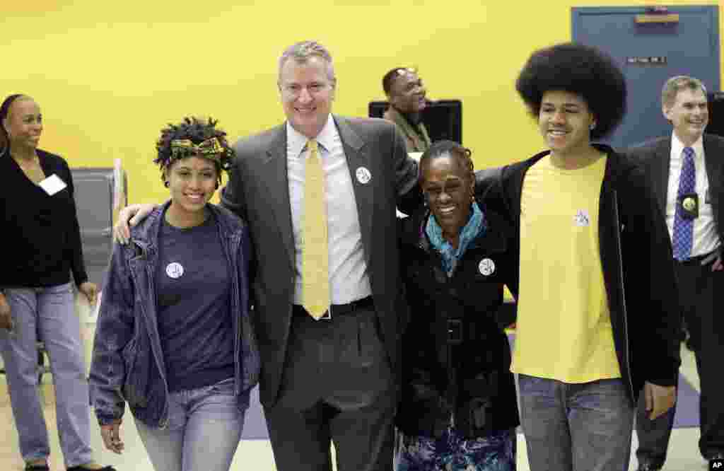 Democratic mayoral candidate Bill de Blasio embraces his family as they exit a polling station, Nov. 5, 2013 in the Park Slope neighborhood of the Brooklyn borough of New York. De Blasio is running against Republican candidate Joseph Lhota.