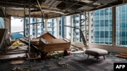 Panels and debris from a collapsed ceiling are seen with blown over pieces of furniture in a company office, in a harbourside commercial building, whose windows were blown out the day before during Typhoon Mangkhut in Hong Kong on September 17, 2018.