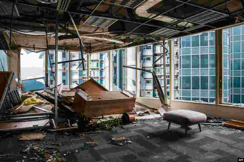 Panels and debris from a collapsed ceiling are seen in a company office of a commercial building in Hong Kong. Windows of the building were blown out during Typhoon Mangkhut in Hong Kong.