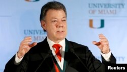 Colombia's President Juan Manuel Santos gestures as he addressed a gathering at the University of Miami in Coral Gables, Florida, Dec. 2, 2013. 