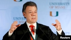 FILE - Colombia's President Juan Manuel Santos gestures as he addressed a gathering at the University of Miami in Coral Gables, Florida, Dec. 2, 2013. 