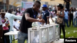 A party delegate casts his vote during the All Progressives Congress (APC) primary election to choose the party's governorship candidate for Lagos state, at Onikan stadium in Lagos, Dec. 4, 2014.