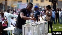 FILE - A party delegate casts his vote during the All Progressives Congress (APC) primary election to choose a governorship candidate for Nigeria's Lagos state, at Onikan stadium in Lagos, Dec. 4, 2014.