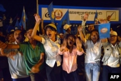 FILE - Supporters of the Cambodian People's Party (CPP) shout slogans during a general election campaign in Kandal province, July 12, 2013.