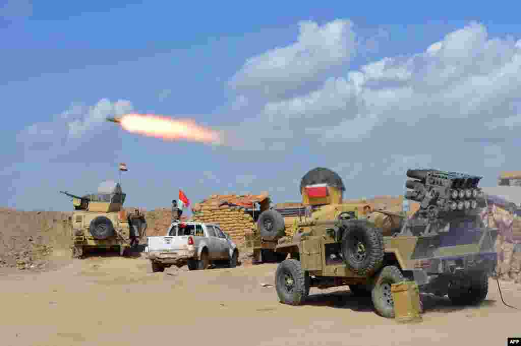Iraqi government forces and allied militias fire weaponry from a position in the northern part of Diyala province, bordering Saladin province, March 2, 2015.