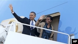 President Barack Obama and first lady Michelle Obama waves as they board Air Force One at Andrews Air Force Base, MD as they begin their trip to Asia. The president will visit India, Indonesia, South Korea, and Japan, 5 Nov 2010