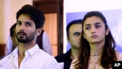 Bollywood film "Udta Punjab," or "Flying Punjab" actors Shahid Kapoor, left, and Alia Bhatt listen to a question during a press conference, in Mumbai, India, Wednesday, June 8, 2016.