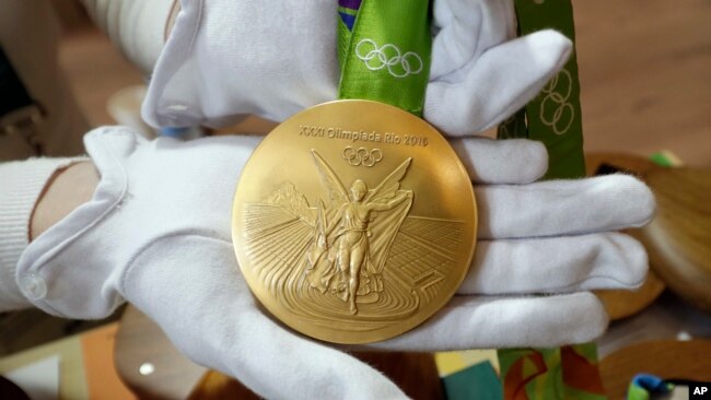 FILE - A Rio 2016 Olympic gold medal is displayed at the Olympic Park in Rio de Janeiro, Brazil, July 20, 2016.
