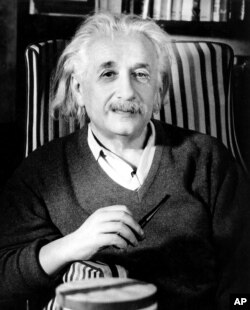 FILE - Prof. Albert Einstein is shown a few days before his 70th birthday in his home in Princeton, N.J., in March 1949.