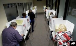 Voters cast ballots at the Santa Clara County Registrar of Voters in San Jose, Calif., Oct. 24, 2016.