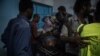 Medical staff attend to a man suffering convulsions from tear gas inhalation at a clinic in the sit-in in Khartoum on the night of May 13 2019. (J. Patinkin for VOA)