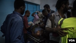 Medical staff attend to a man suffering convulsions from tear gas inhalation at a clinic in the sit-in in Khartoum on the night of May 13 2019. (J. Patinkin for VOA)