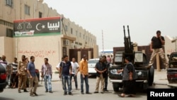 Members of armed revolutionaries stage a protest in front of the Libyan Justice Ministry in Tripoli, April 30, 2013.
