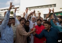 Supporters of Pakistan Tahreek-e-Insaf party headed by Imran Khan, celebrate the success of their leader outside the National Assembly in Islamabad, Pakistan, Aug. 17, 2018.