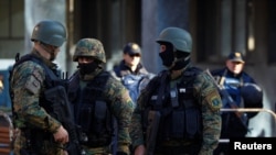 Heavily armed Macedonian police guard the premises of a court, during the final verdict for 37 people arrested and charged with terrorism-related offenses for clashes with Macedonian police in 2015 in Kumanovo, in Skopje, Macedonia, Nov. 2, 2017.