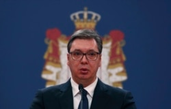 In this March 15, 2020, photo, Serbian President Aleksandar Vucic speaks during a news conference in Belgrade, Serbia. Since declaring nationwide state of emergency Vucic has suspended parliament, giving him widespread powers.