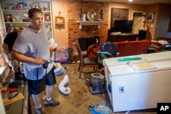 Raymond Lieteau takes photos his flood-damaged home in Baton Rouge, Louisiana, Aug. 16, 2016. Lieteau had more than five feet of water in his home.